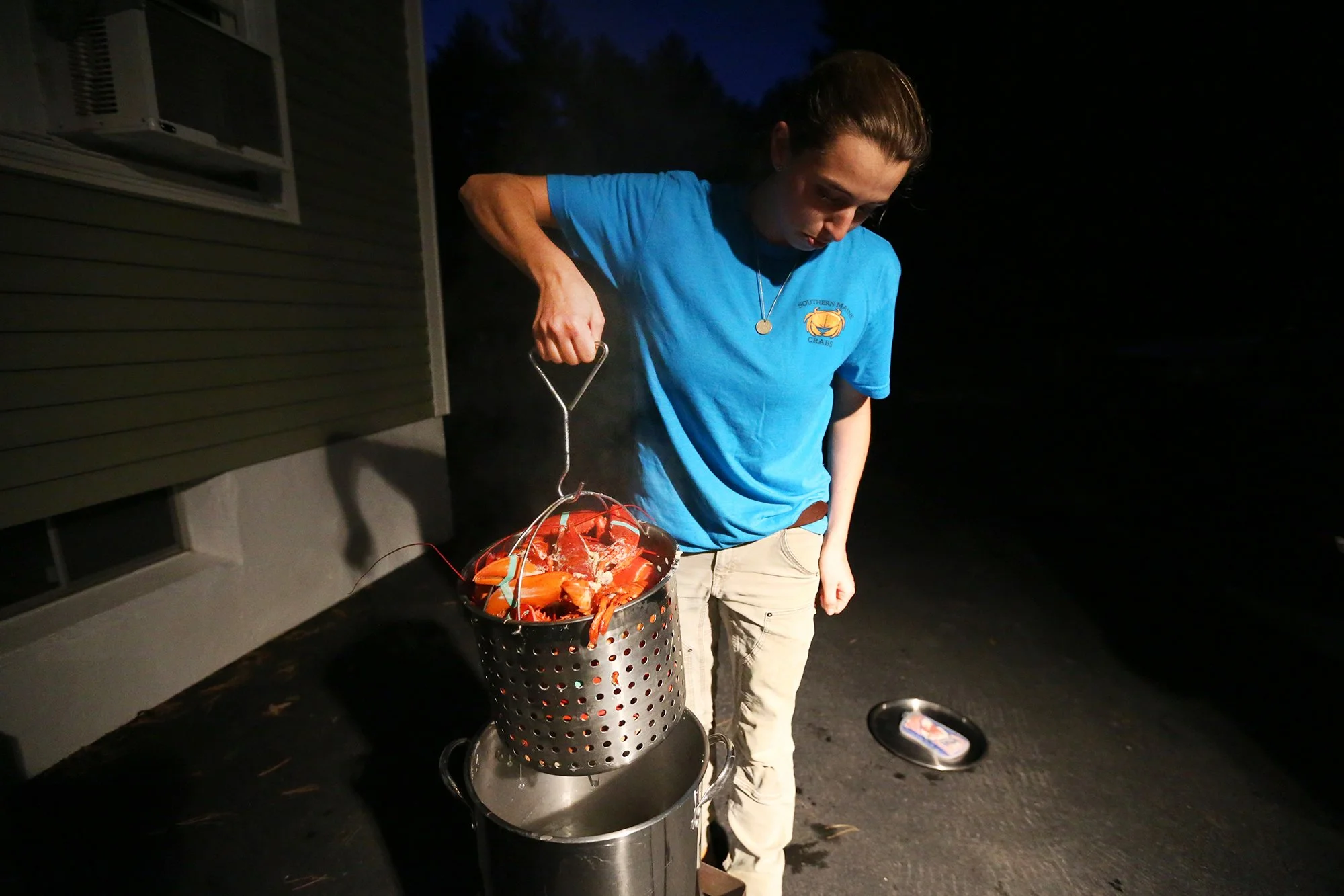 Jillian Robillard boils lobsters and crabs for dinner at her Kittery home on October 22, 2021.
