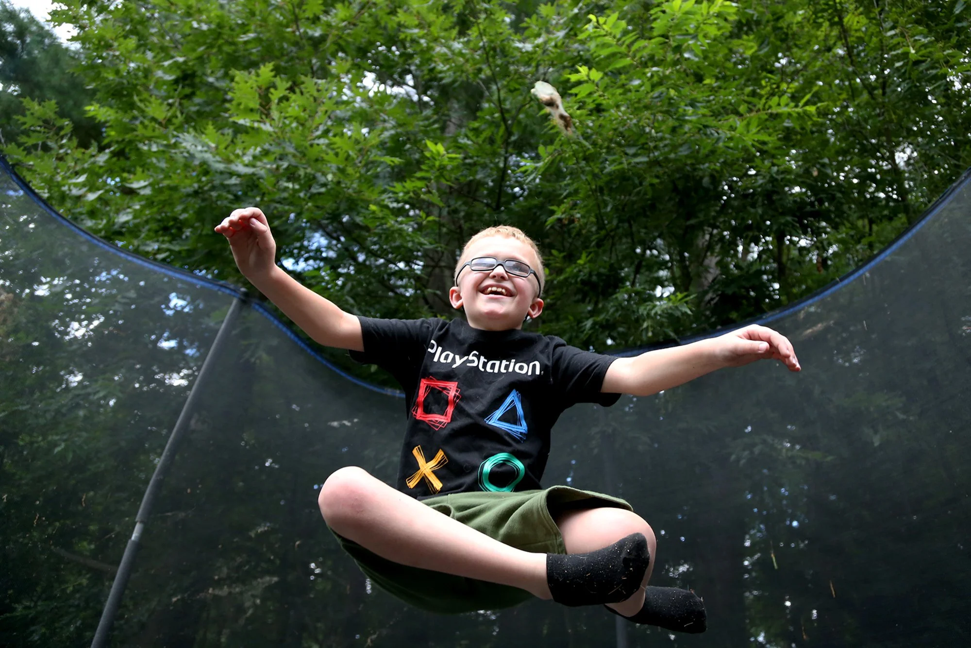 Brycen Berube, 9, is currently undergoing treatment for an incurable genetic disease called Neurofibromatosis, but eagerly comes home to jump on his trampoline after treatment on July 28, 2021.  