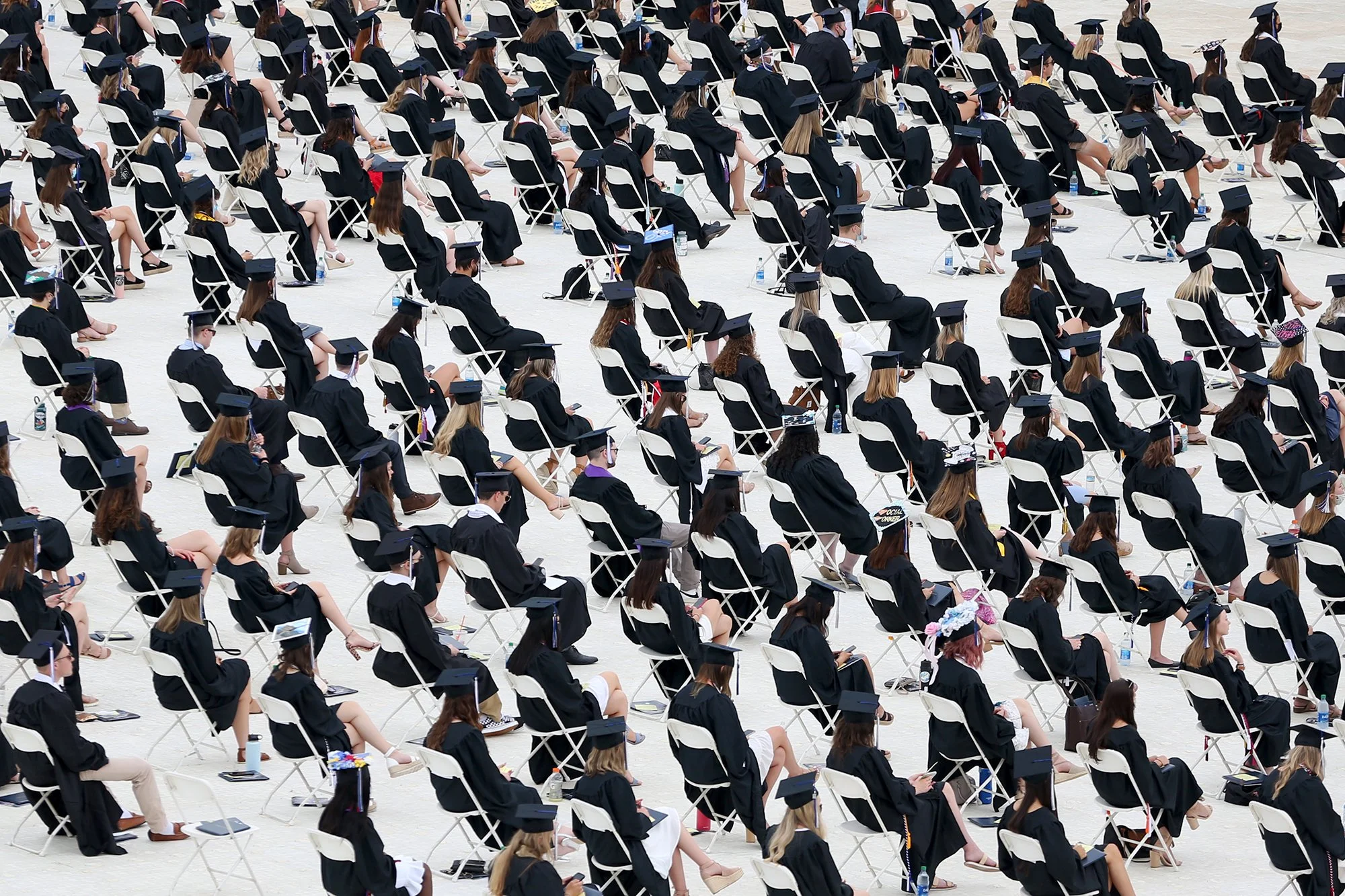 Graduates practice social distancing during the University of New Hampshire Commencement on May 21, 2021 in Durham.