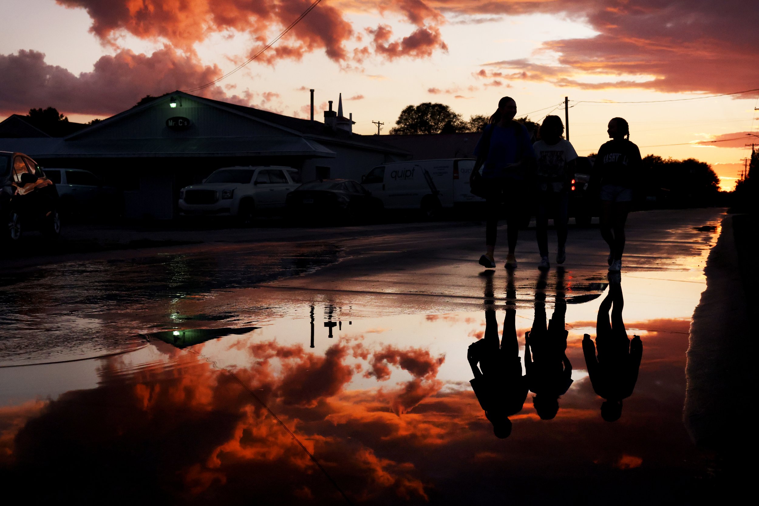 From left, Kayton Harris, Malinda Harris and Alyssa walk to the Delta Fair as a family.