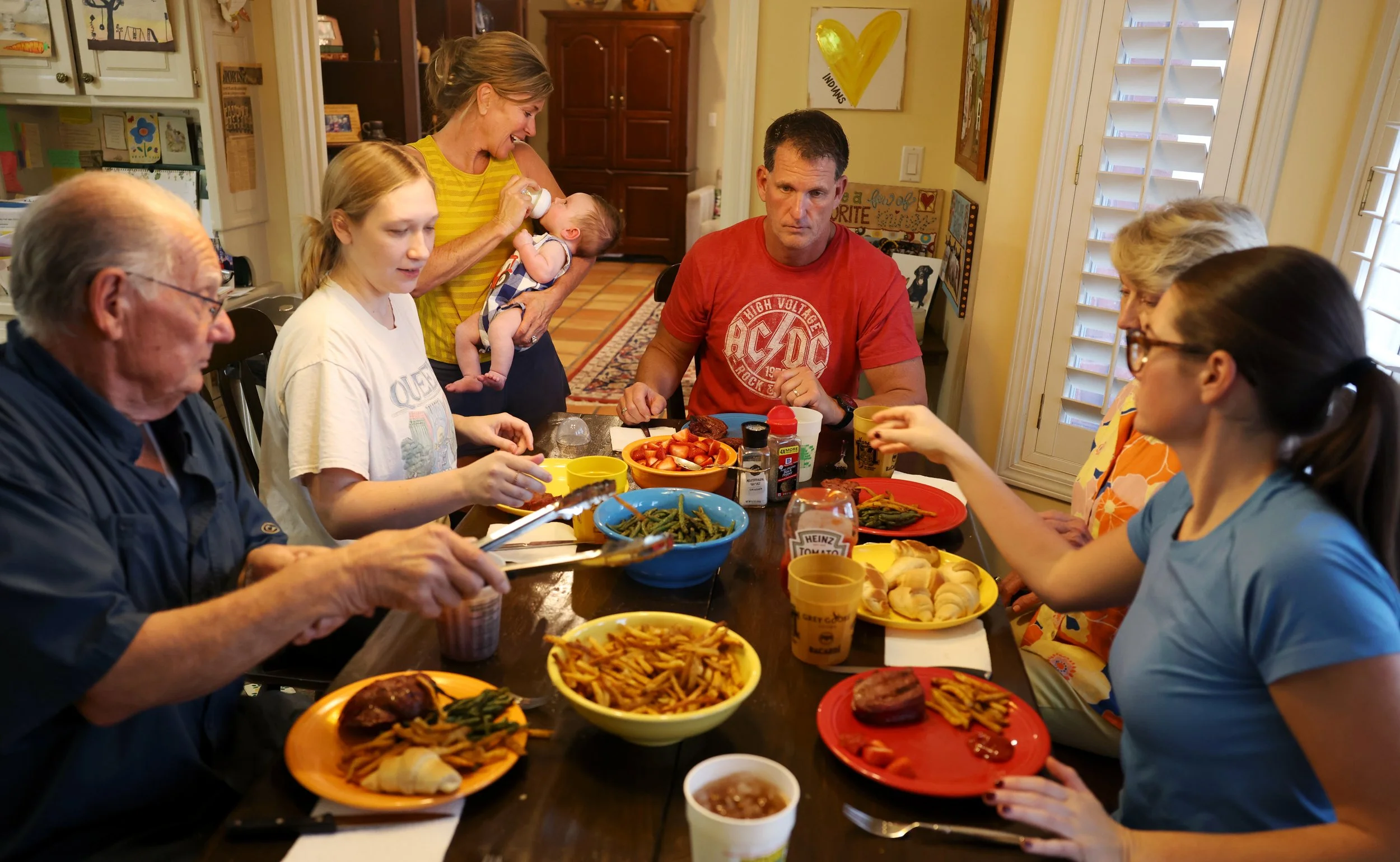 From left, Ron Harris, Ragan Harris, Malinda Harris, Henry Harris, Darren Harris, Eky Combs and Kayton Harris eat dinner together as a family on Monday, Sept. 23, 2024, in Kennett, Mo. 