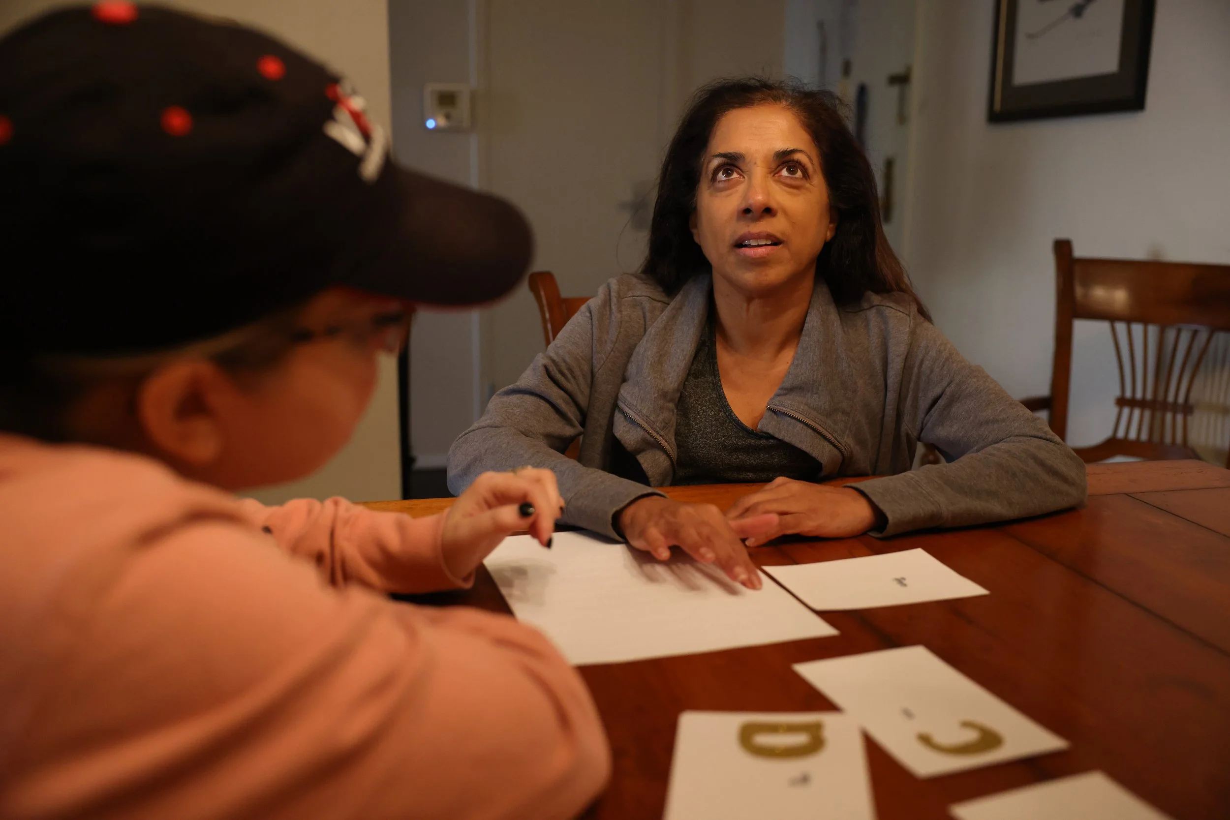 Nisha Falcigno learns braille on a tracking sheet with Visions rehabilitation therapist Frankie Ann Marcille on Nov. 14, 2023. 