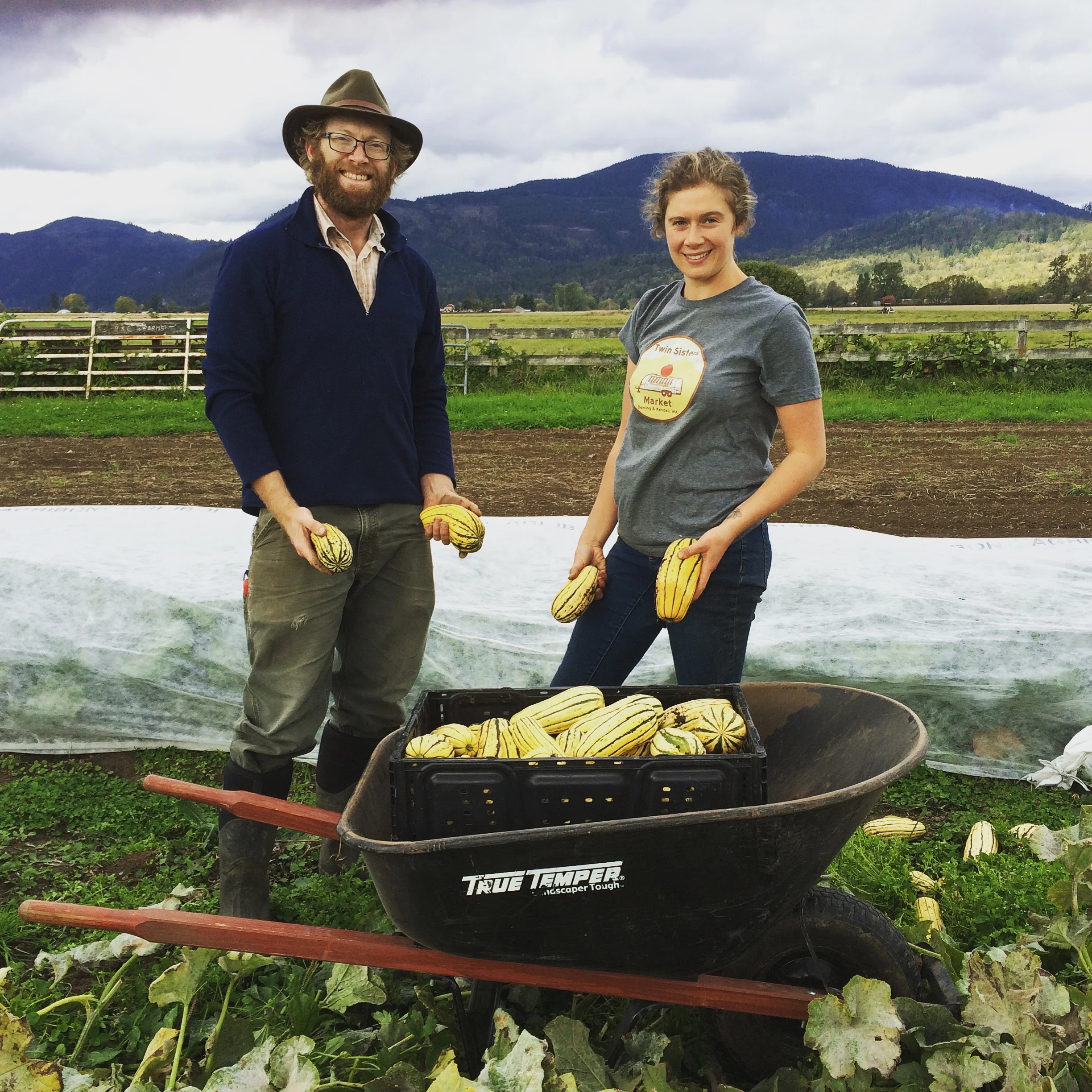 Max and Lily from Bellingham Food Bank; helping to harvest delicata squash grown by Blanchard Mountain Farm for the food bank