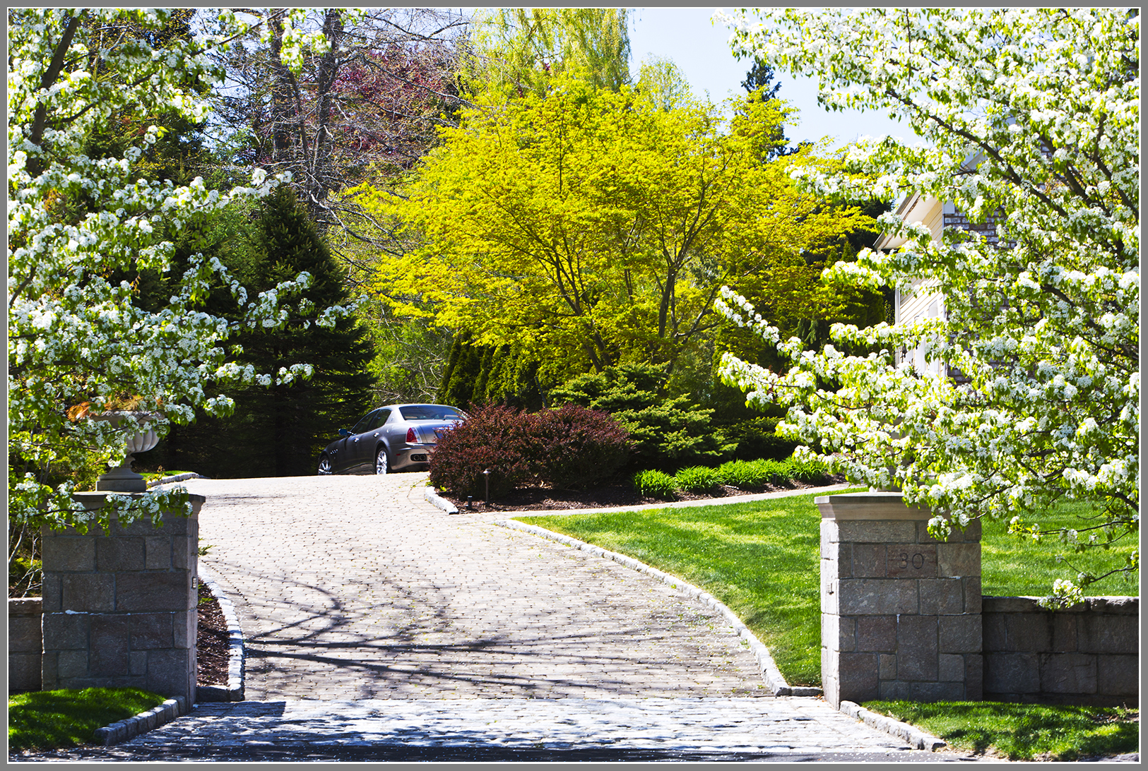 Granite Columns, wall, cobblestone apron and paver driveway