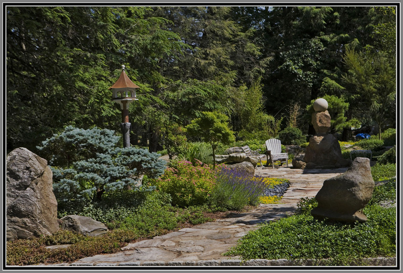 Flag stone walkway with beautiful garden and ornaments