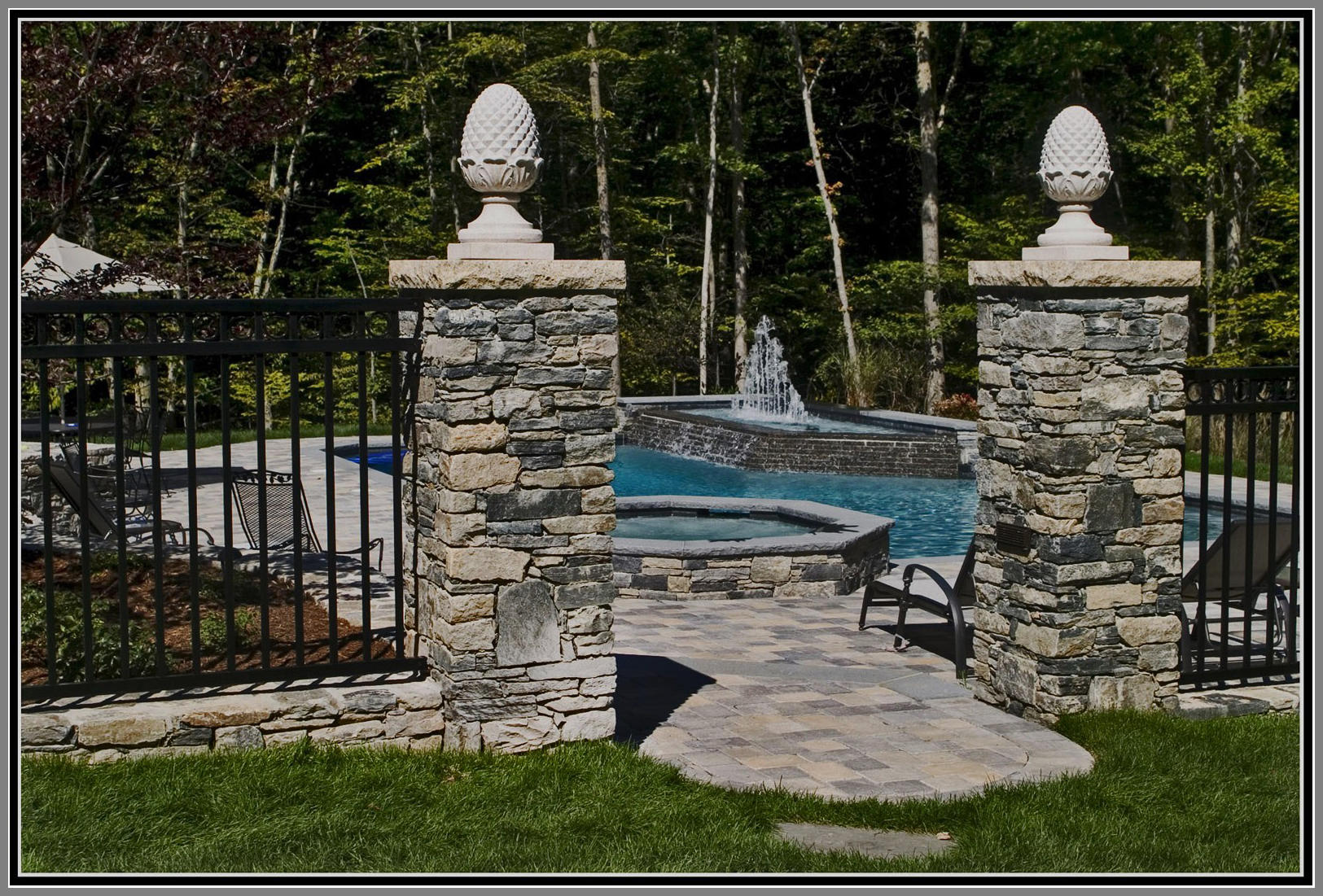 Wrought iron fence and gate with stone columns