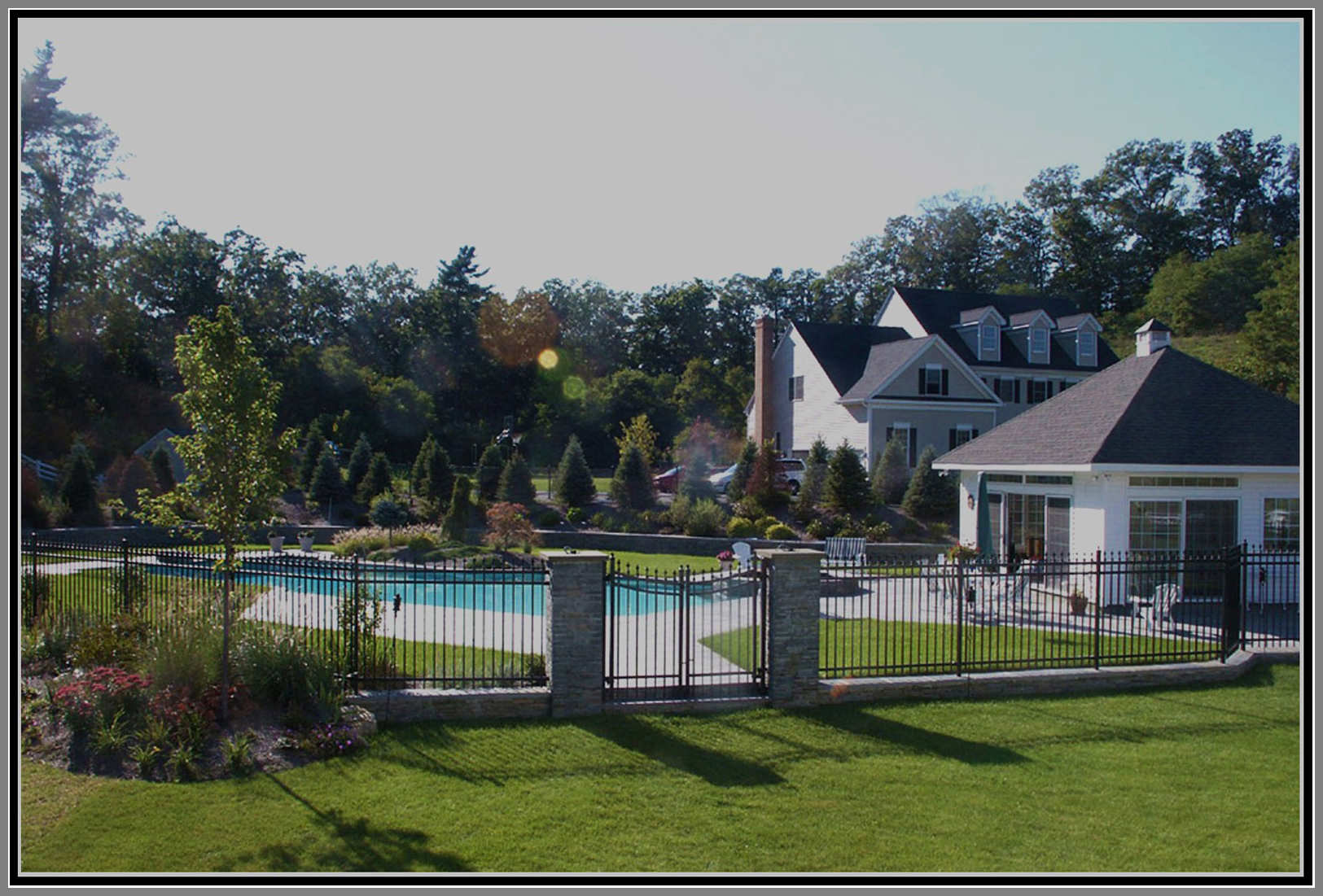 Aluminium pool fence with stone column