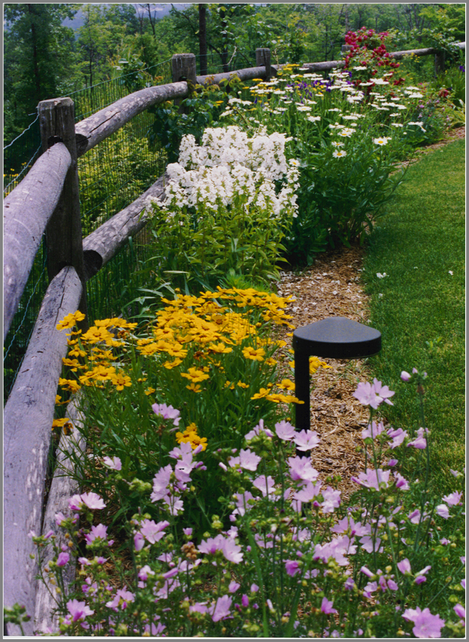 Post and rail fence with gardens
