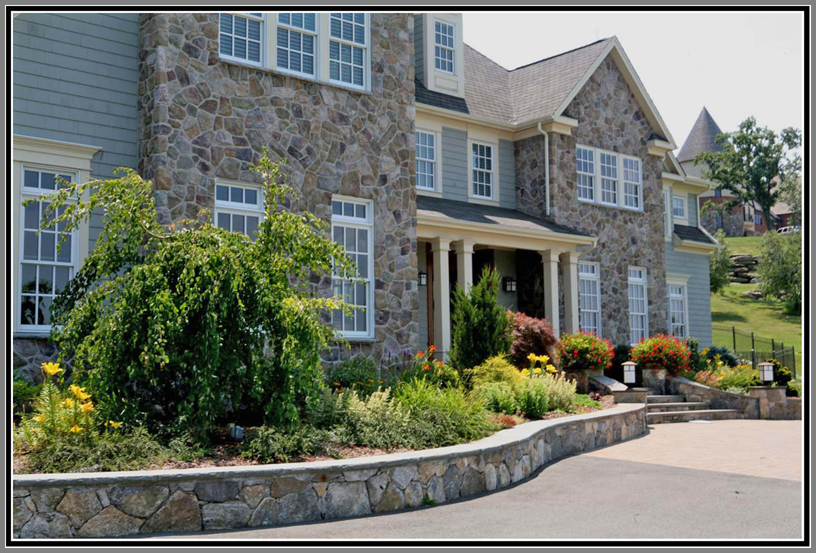 Foundation plantings with stone wall