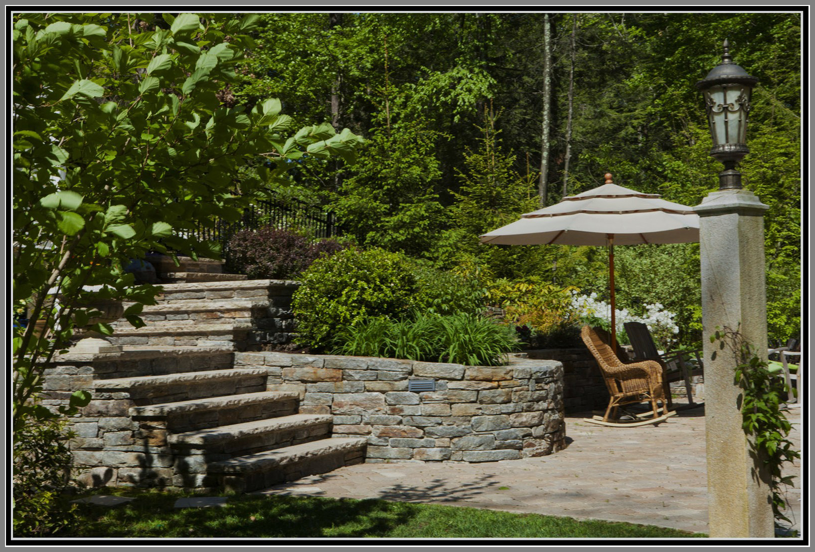 Terrace garden with stone walls and steps by Artistic Outdoors