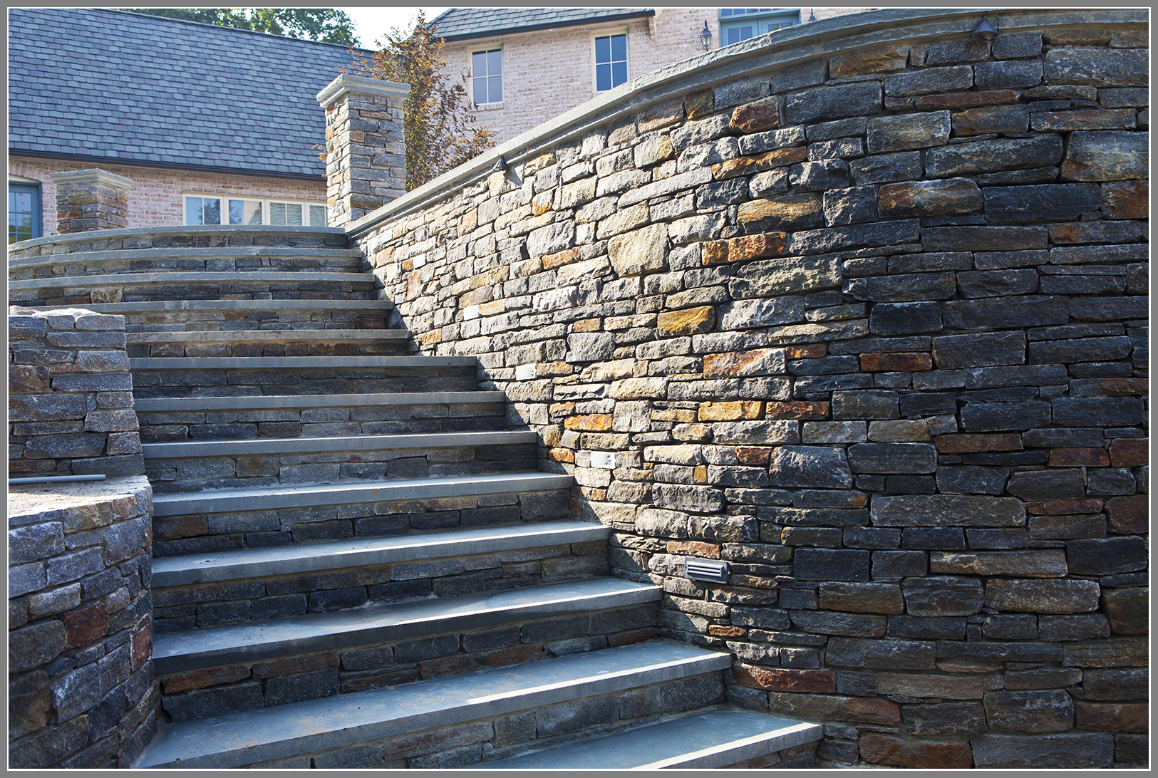 Stone wall and steps with bluestone cap