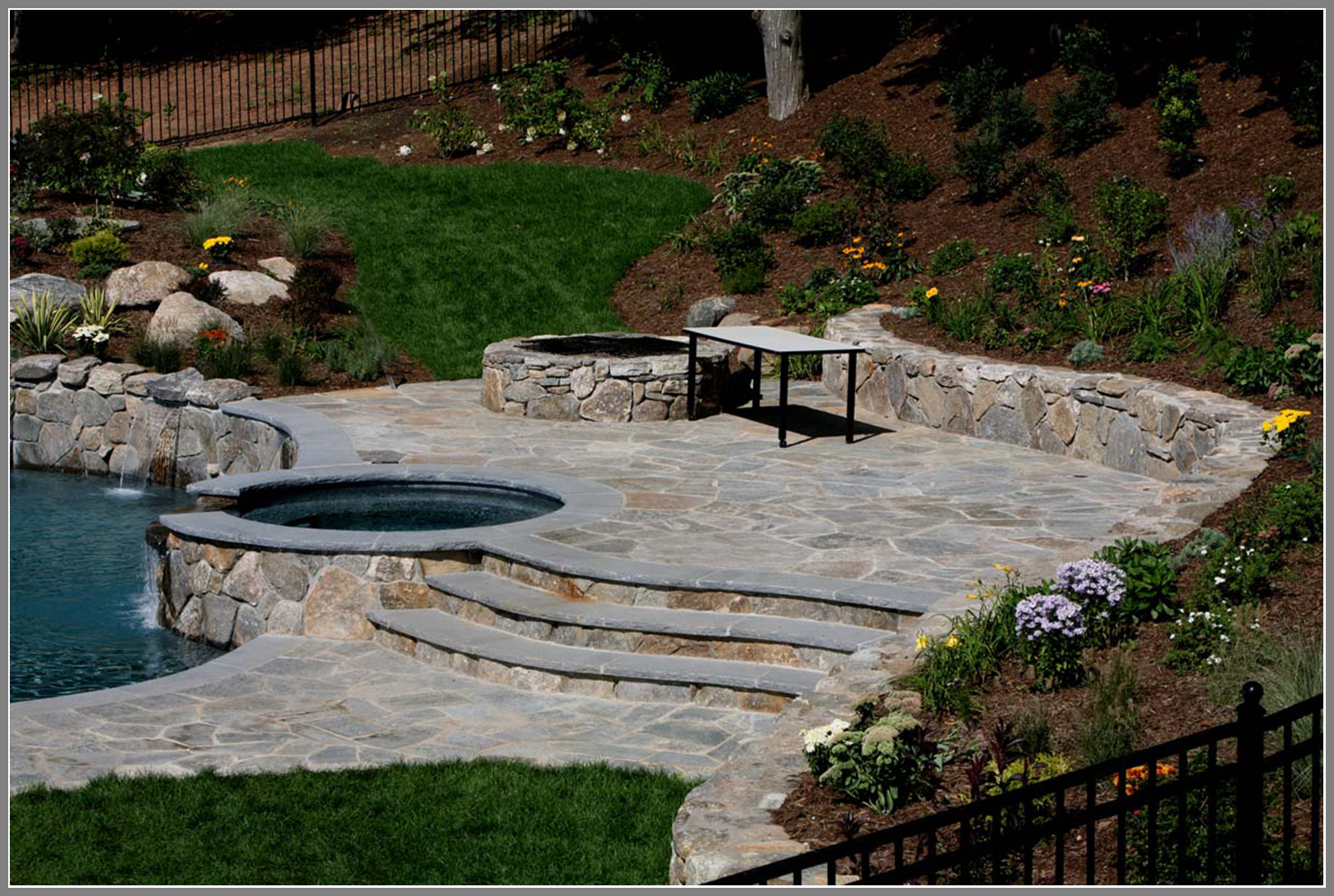 Flagstone pool deck and stone wall