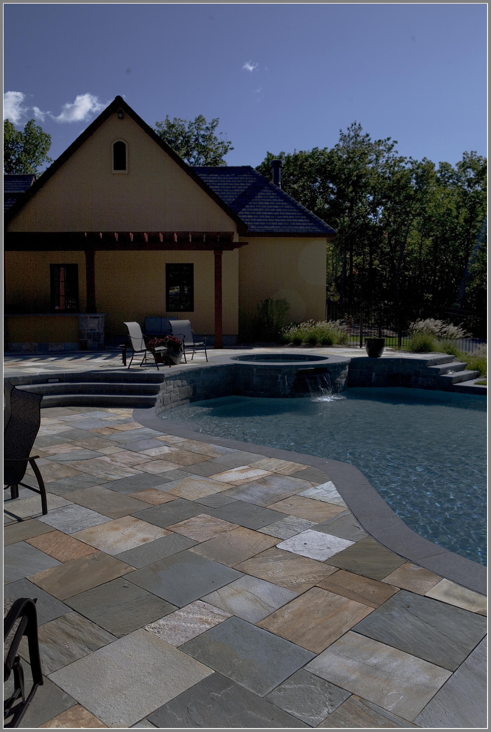 stone pool deck by Artistic Outdoors