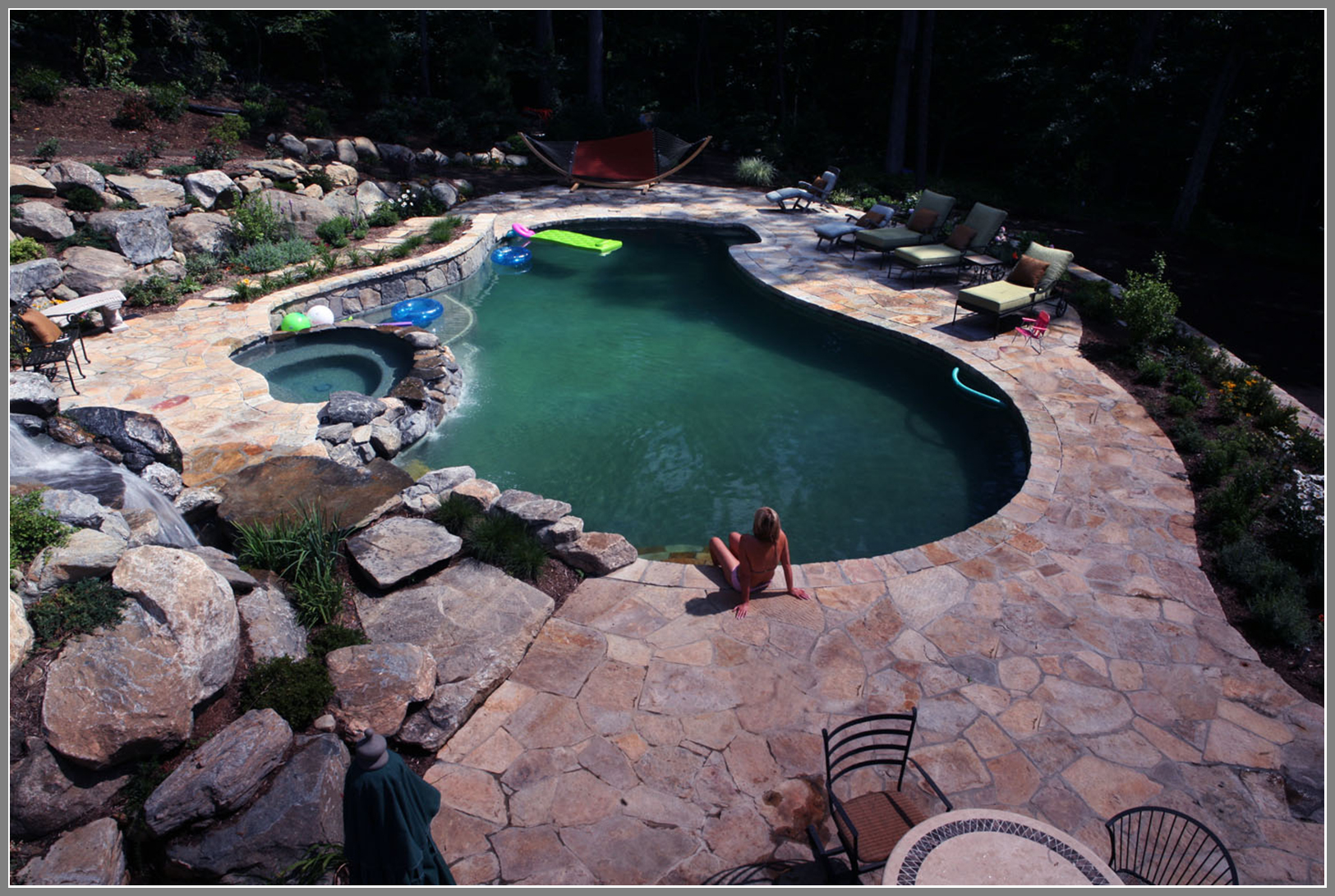 Stone pool deck by Artistic Outdoors