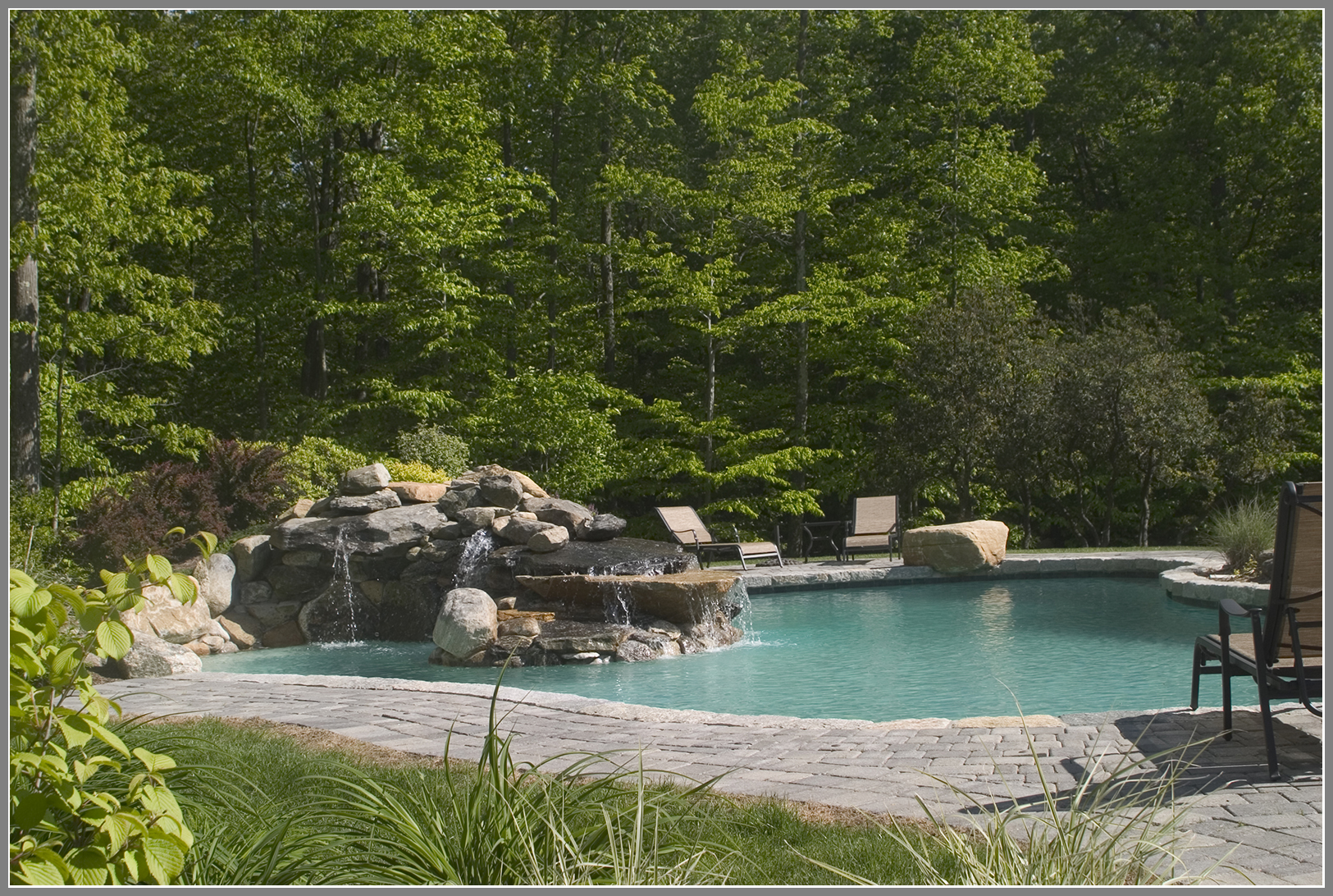 Swimming pool design with lagoon and waterfalls. 