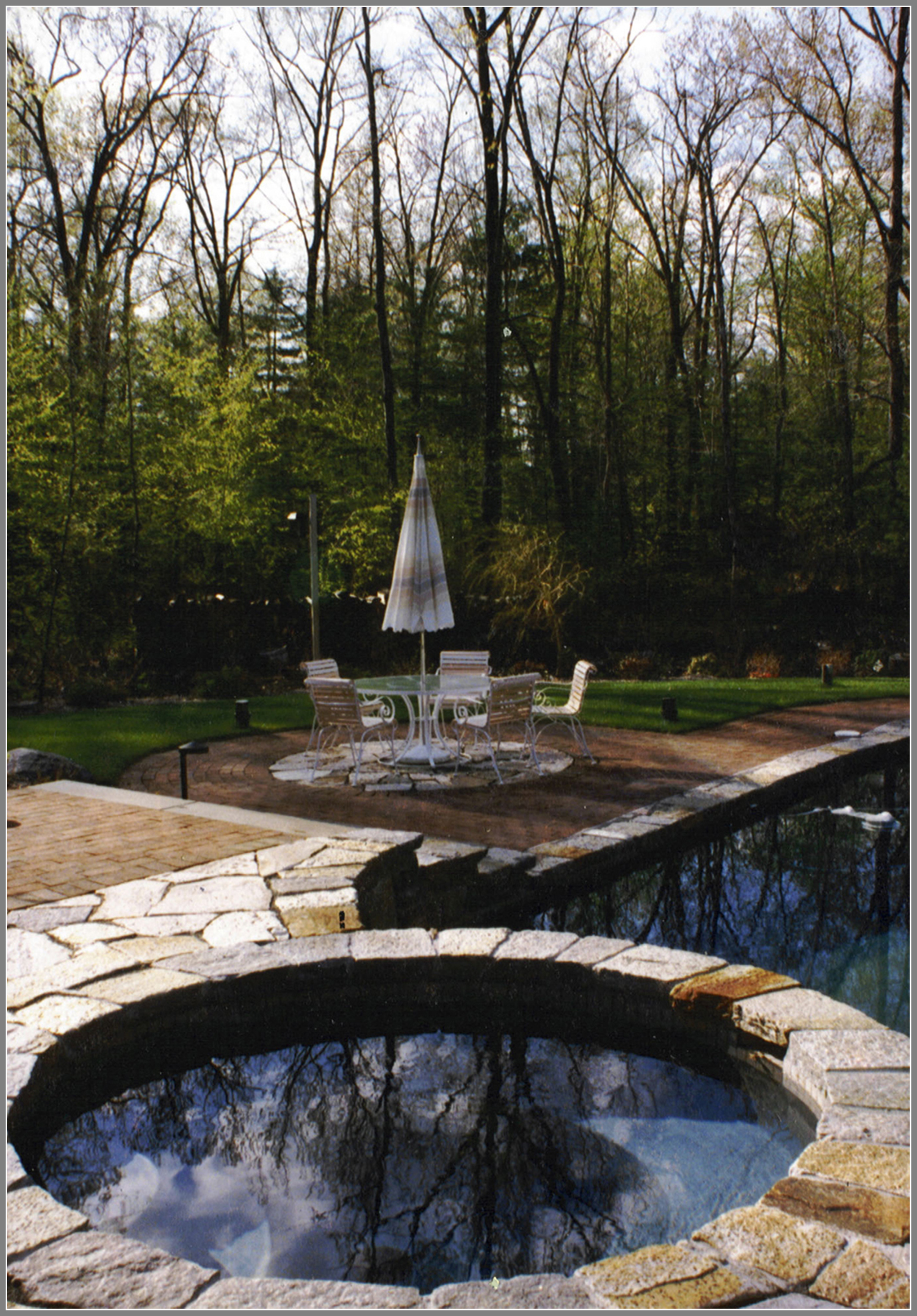 Swimming pool with granite coping and brick patio
