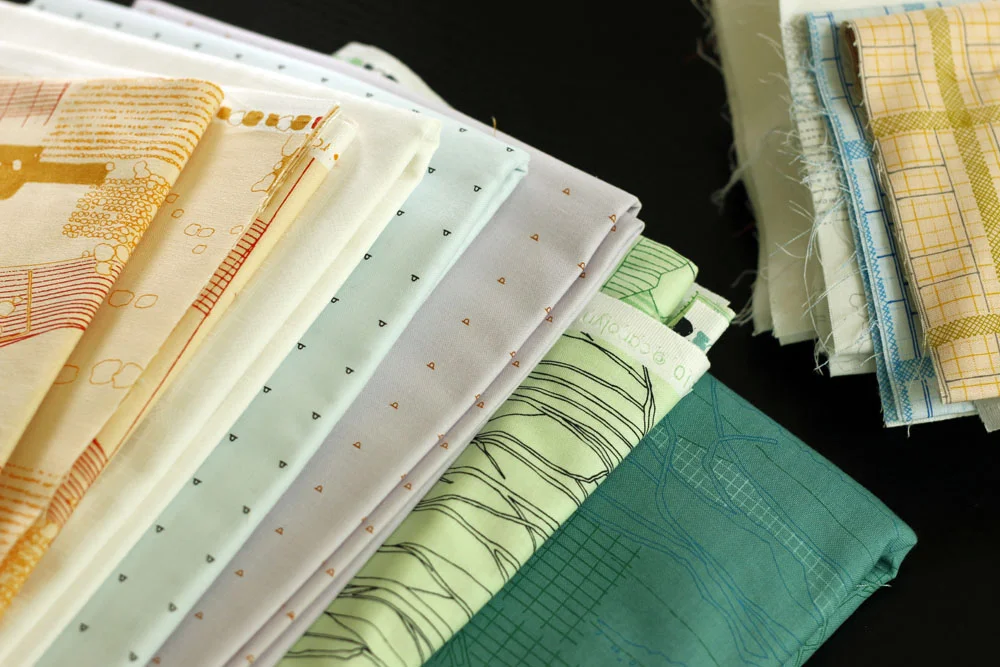 from left Fabrics are: Aerial Tangerine , Elevation White , Shirting Sky , Shirting Orchid , Tree Stripe Pistachio , The Cattle Sage .