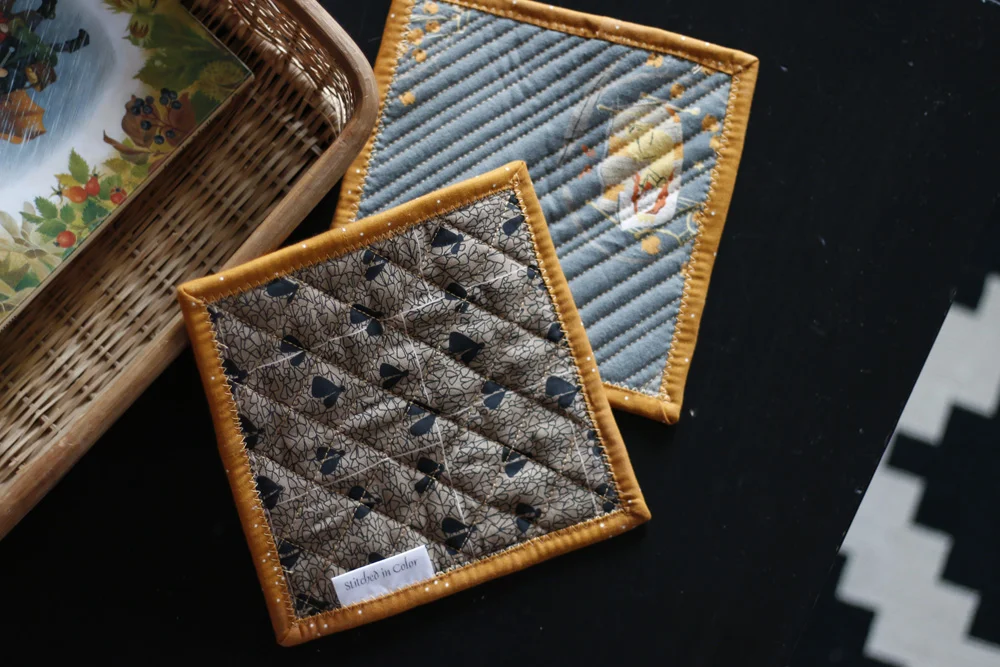 Potholders quilted with zigzag binding. Stitched in Color.jpg