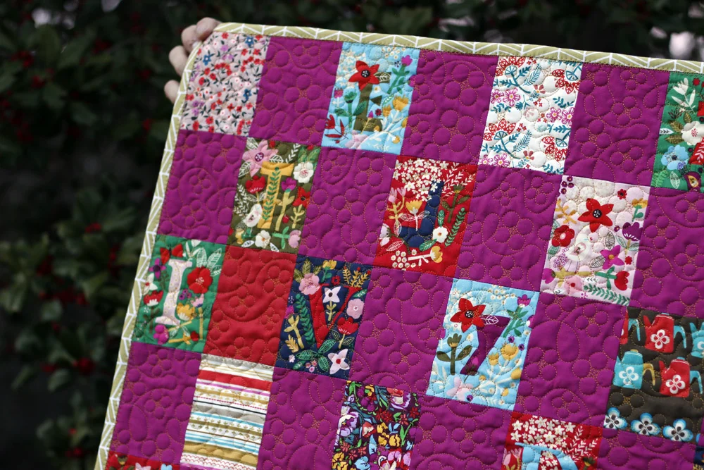 Bound baby quilt. Stitched in Color.jpg