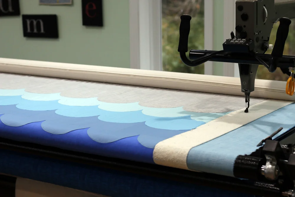Wave quilt on longarm. StitchedinColor.jpg