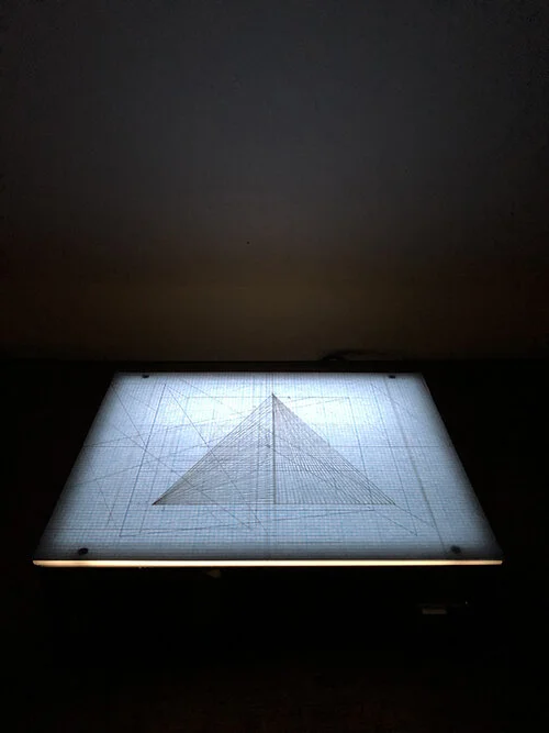Floating on the Horizon Line of Humanity Exist Numbers Equating to 1. Flower and Pyramid, graphite on bond paper placed on light box, drawings 9 ¾ x 12 ¼ overall 9 ¾ x 12 ¼ x 3 ¼”, 2019.