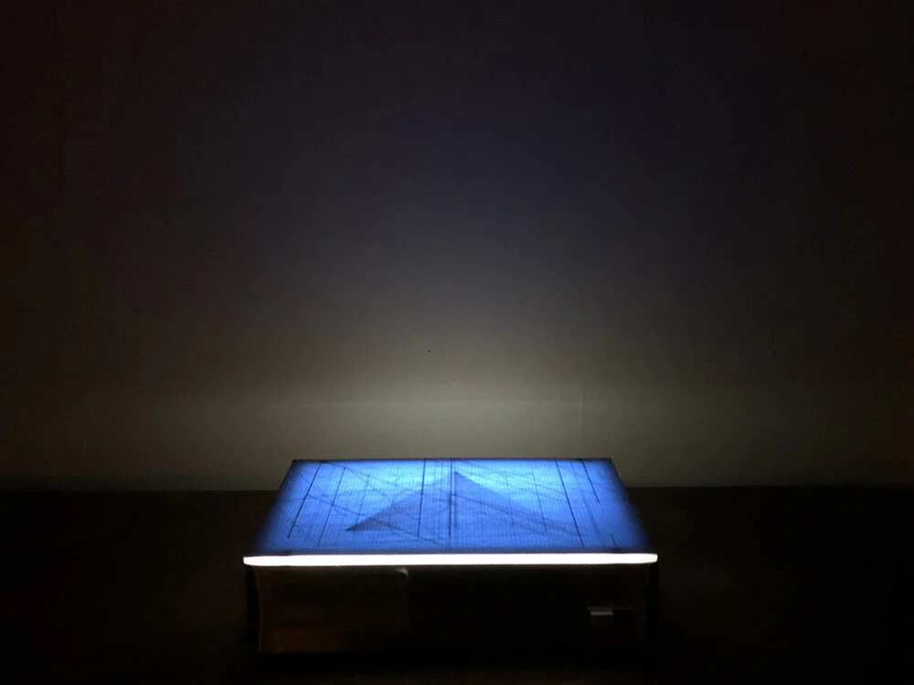 Floating on the Horizon Line of Humanity Exist Numbers Equating to 1. Ten drawings, graphite on bond paper placed on light box, drawings 9 ¾ x 12 ¼ overall variable 9 ¾ x 12 ¼ x 3 ¼”, 2019.