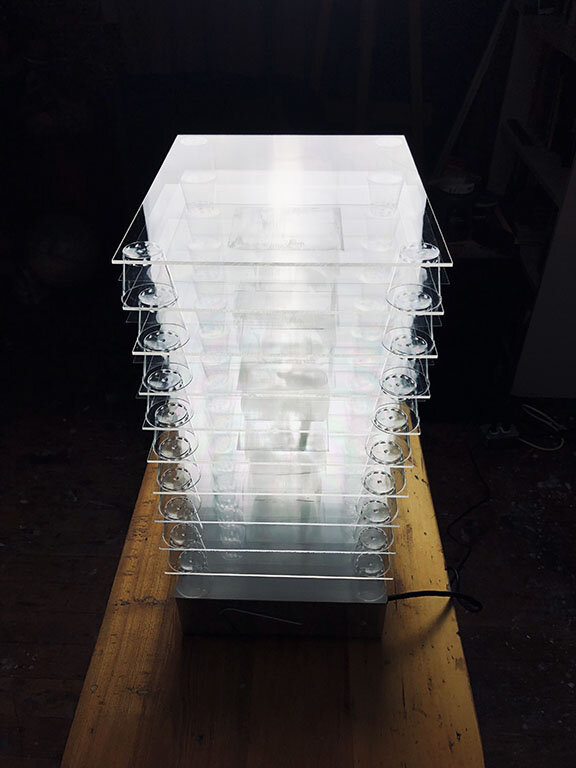  Interference Monochrome Sculpture. As Seen From the Front and Slightly Above by Higher Beings But Not Ordained. Polymer emulsion, acetate, plastic cups, light table, 10x13x32”. Plastic Transcendence Series 2020. 