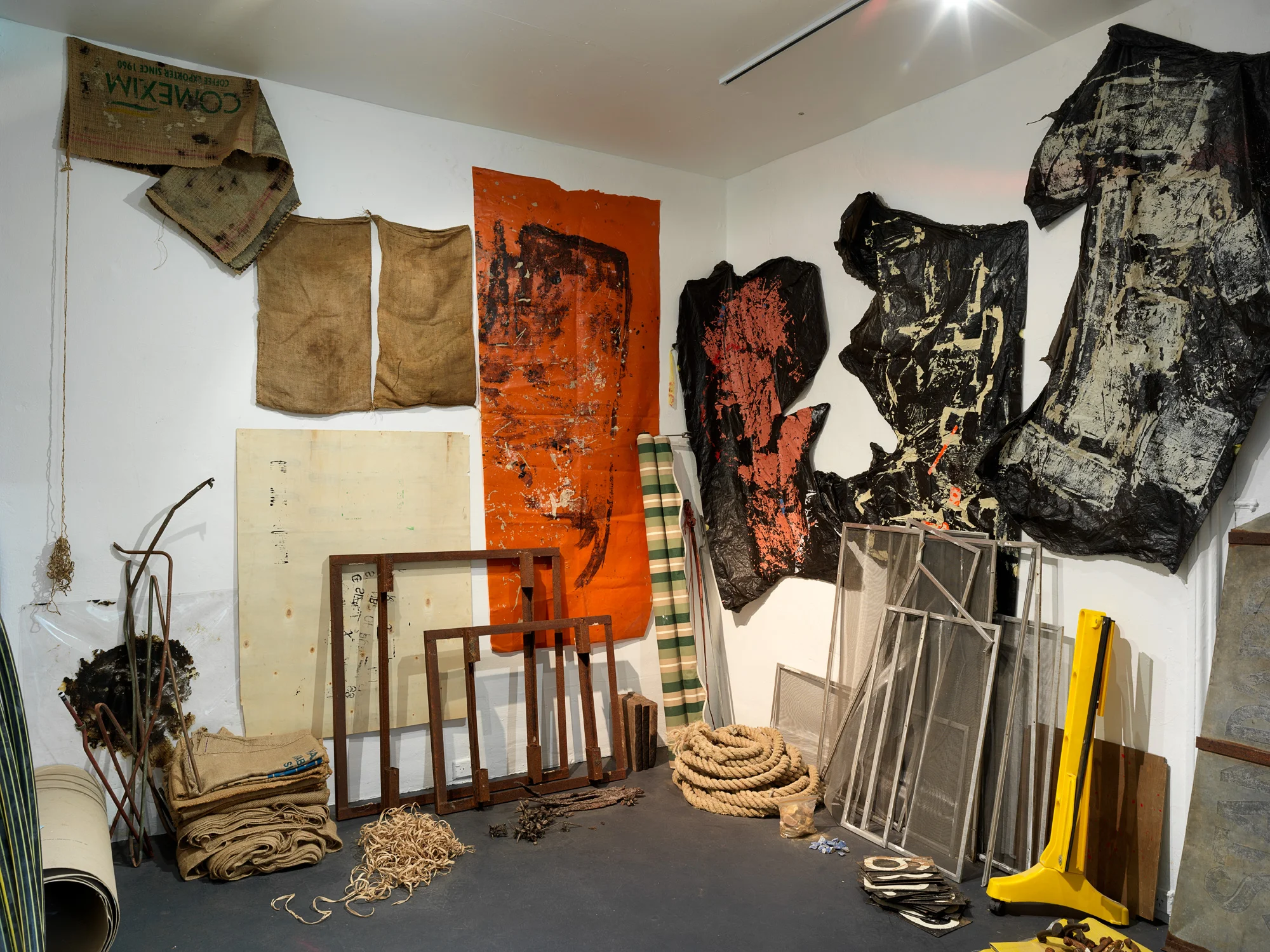 Precious Things (detail), 2018 Metal braces, metal scoreboard numbers, length of hessian, hessian bags (various), fly wire screens, mooring rope, aged tarpaulin, metal rod with synthetic rope attached, wooden trellis, pieces of wood, awning, shovel head, copper piping, rubber gloves, windmill blades, roll of used ram board, cardboard pieces, metal frames (oven), plastic gas piping, plastic hazard stand, plastic polythene sheets, plywood, electronic component (oven), wooden stool, rusted pieces of piping, tree bark, seed pods, metal signs, telegraph insulators, local rocks, lapis lazuli, plastic (clear and opaque), studio leftovers/experiments, paint, bitumen rubber, tape, nails. 300 x 300 x 280 cm Photograph Grant Hancock
