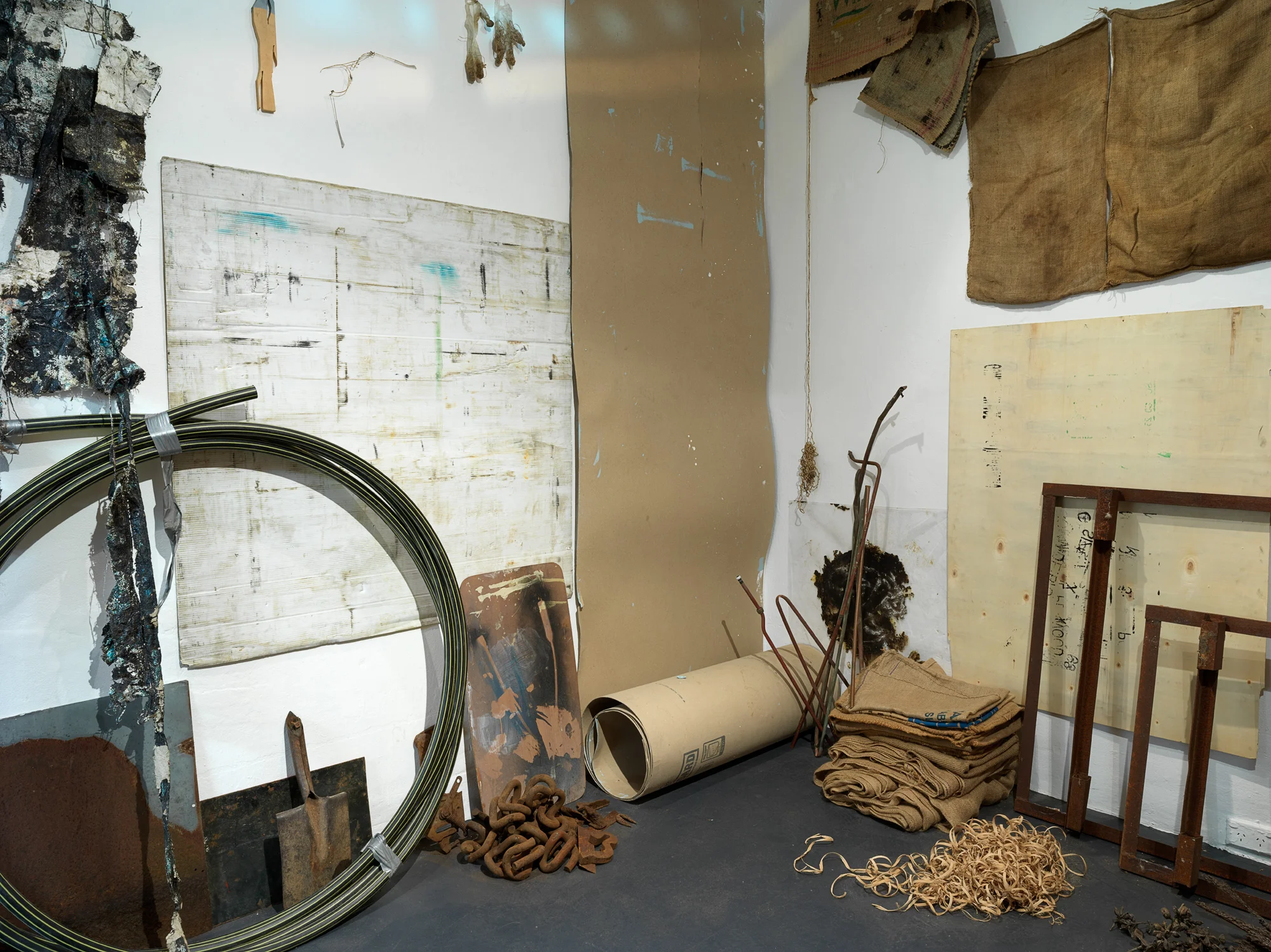 Precious Things (detail), 2018 Metal braces, metal scoreboard numbers, length of hessian, hessian bags (various), fly wire screens, mooring rope, aged tarpaulin, metal rod with synthetic rope attached, wooden trellis, pieces of wood, awning, shovel head, copper piping, rubber gloves, windmill blades, roll of used ram board, cardboard pieces, metal frames (oven), plastic gas piping, plastic hazard stand, plastic polythene sheets, plywood, electronic component (oven), wooden stool, rusted pieces of piping, tree bark, seed pods, metal signs, telegraph insulators, local rocks, lapis lazuli, plastic (clear and opaque), studio leftovers/experiments, paint, bitumen rubber, tape, nails. 300 x 300 x 280 cm Photograph Grant Hancock