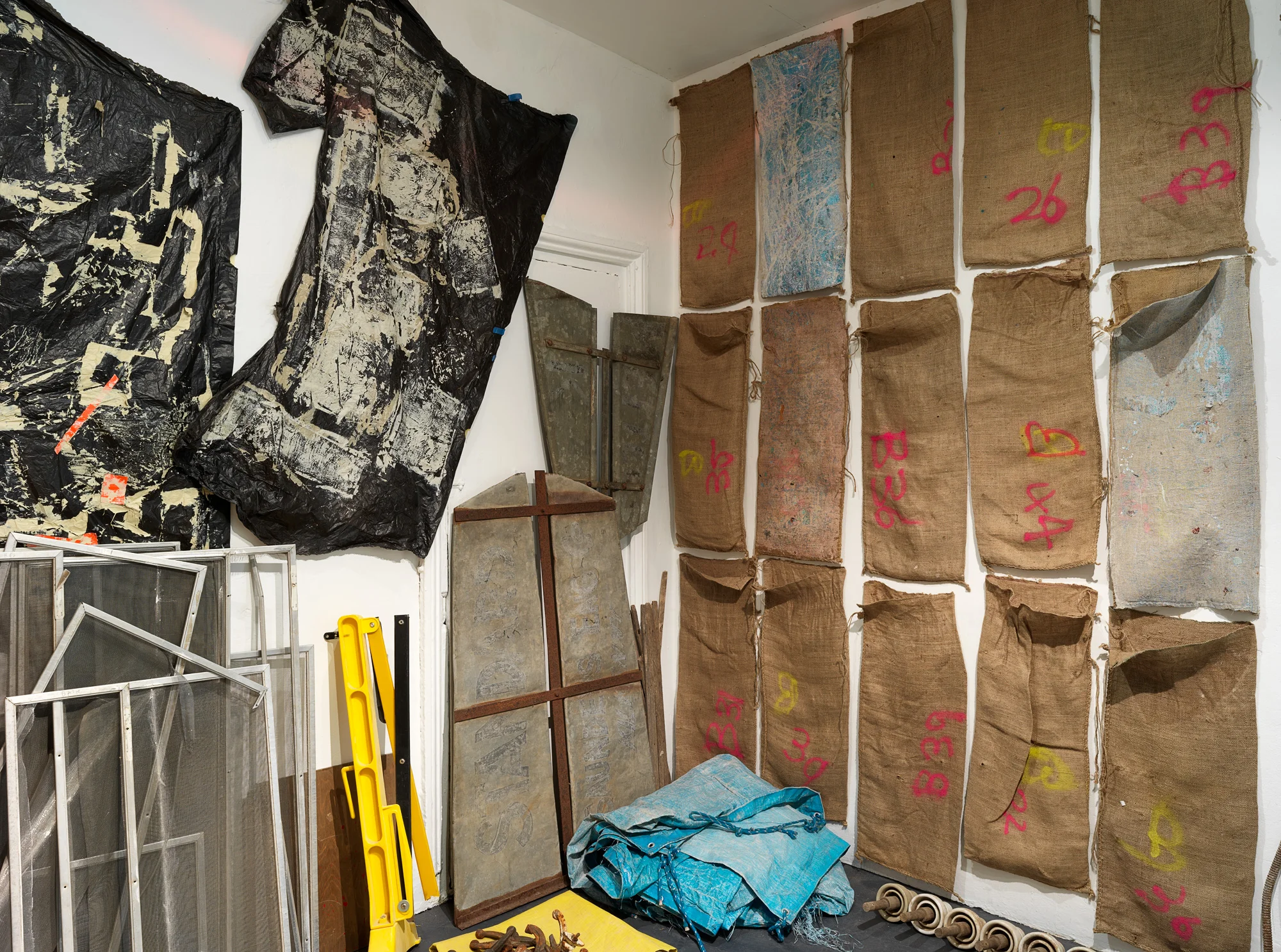 Precious Things (detail), 2018 Metal braces, metal scoreboard numbers, length of hessian, hessian bags (various), fly wire screens, mooring rope, aged tarpaulin, metal rod with synthetic rope attached, wooden trellis, pieces of wood, awning, shovel head, copper piping, rubber gloves, windmill blades, roll of used ram board, cardboard pieces, metal frames (oven), plastic gas piping, plastic hazard stand, plastic polythene sheets, plywood, electronic component (oven), wooden stool, rusted pieces of piping, tree bark, seed pods, metal signs, telegraph insulators, local rocks, lapis lazuli, plastic (clear and opaque), studio leftovers/experiments, paint, bitumen rubber, tape, nails. 300 x 300 x 280 cm Photograph Grant Hancock