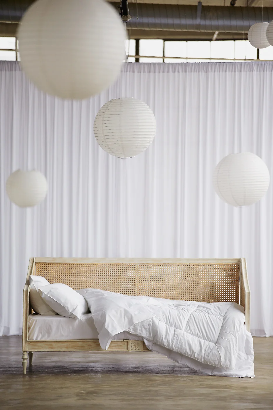 Stacey Van Berkel Photography I Rattan daybed with dreamy white duvet and pillows I Palu Furniture