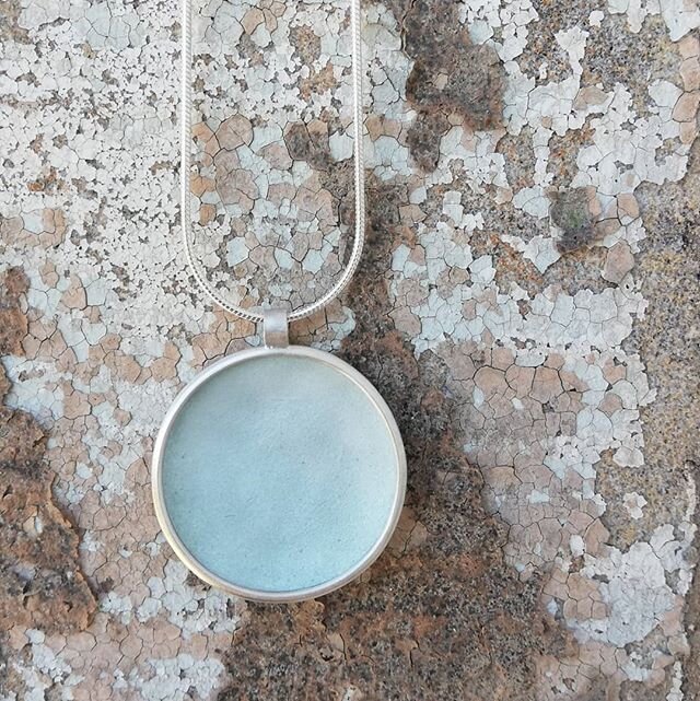 A pendant for today's #artistssupportpledge offering. Pale green/grey enamel on silver, the pendant measures 25mm diameter and can be on a 16 or 20 inch snake chain. The third image shows size, it is a blue version which I don't have available at pre