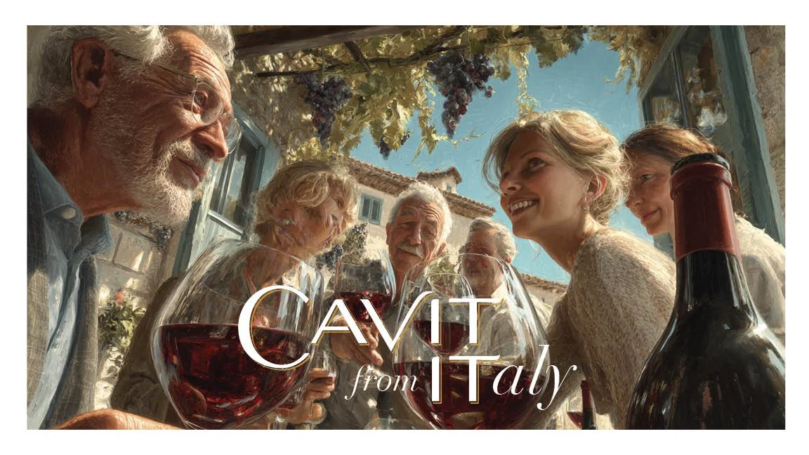 A group of older adults and a younger woman enjoying wine outdoors, with a bottle of red wine and glasses, under a floral-covered pergola in Italy.