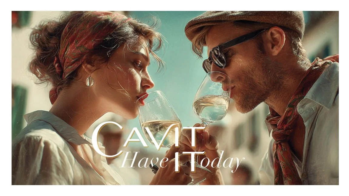 A woman and a man wearing vintage clothing and sunglasses, touching glasses of white wine in a toast, outdoors on a sunny day.