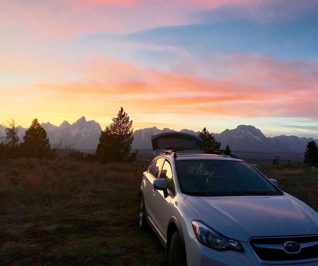 Sleeping in my subaru and watching the sun set over the tetons.