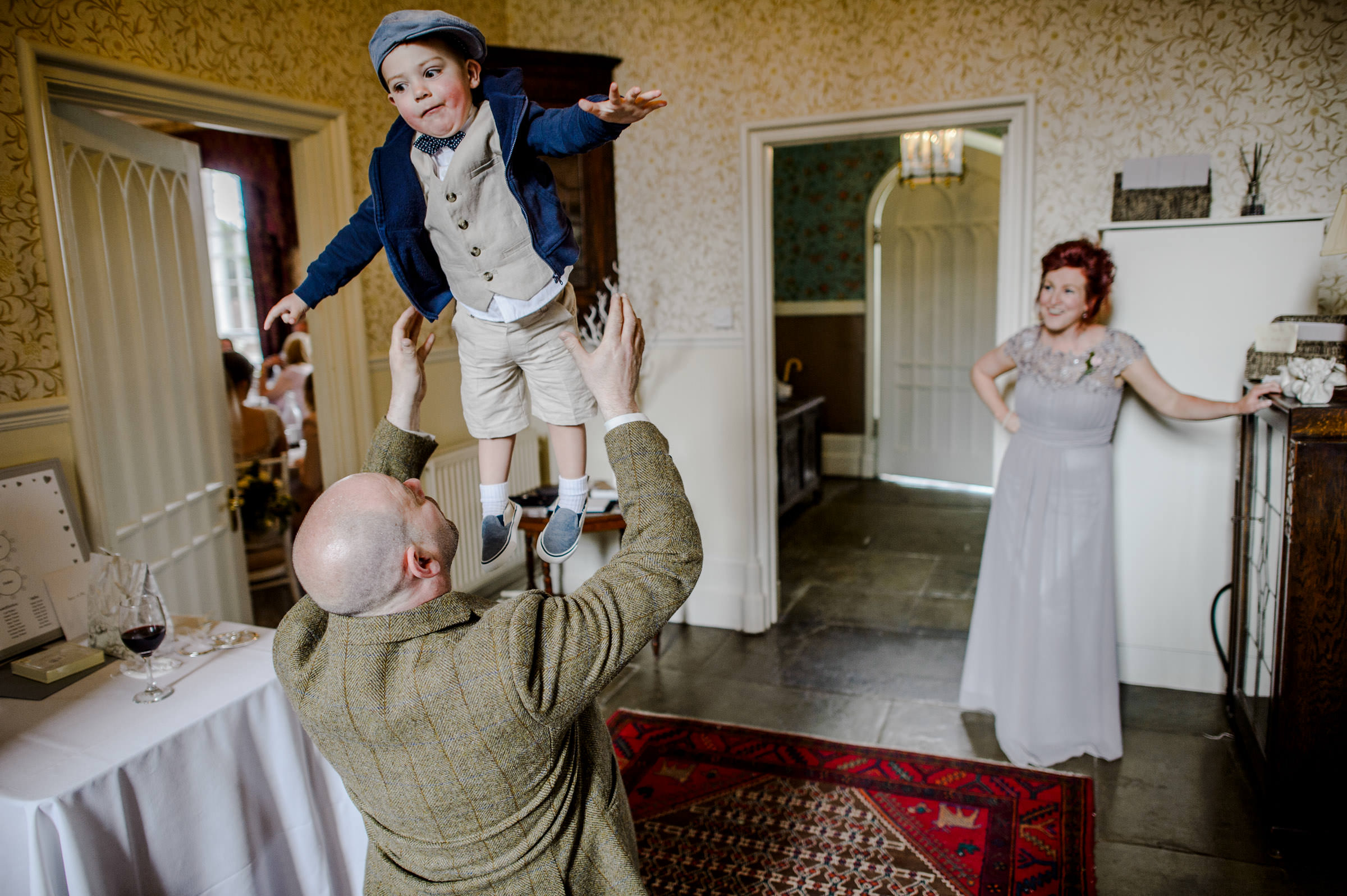 wedding photo of an usher throwing a pageboy up in the air.jpg