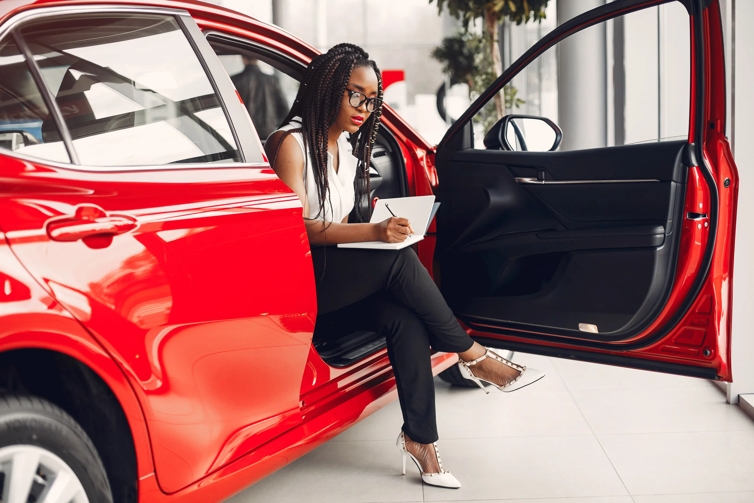 stylish-black-woman-in-a-car-salon-SGKXCD8.jpg