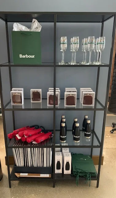 Barbour and QG teamed up to give champagne flutes, water bottles, umbrellas, and flasks as gifts with purchase.