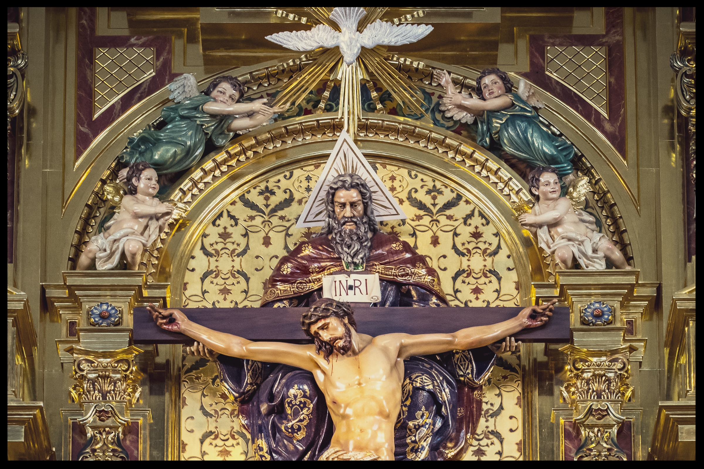 The Holy Trinity as the Throne of Mercy, with God the Father holding the Crucifix and the Holy Spirit flying above in the form of a dove. Photography by Roderick Fenn ©2017