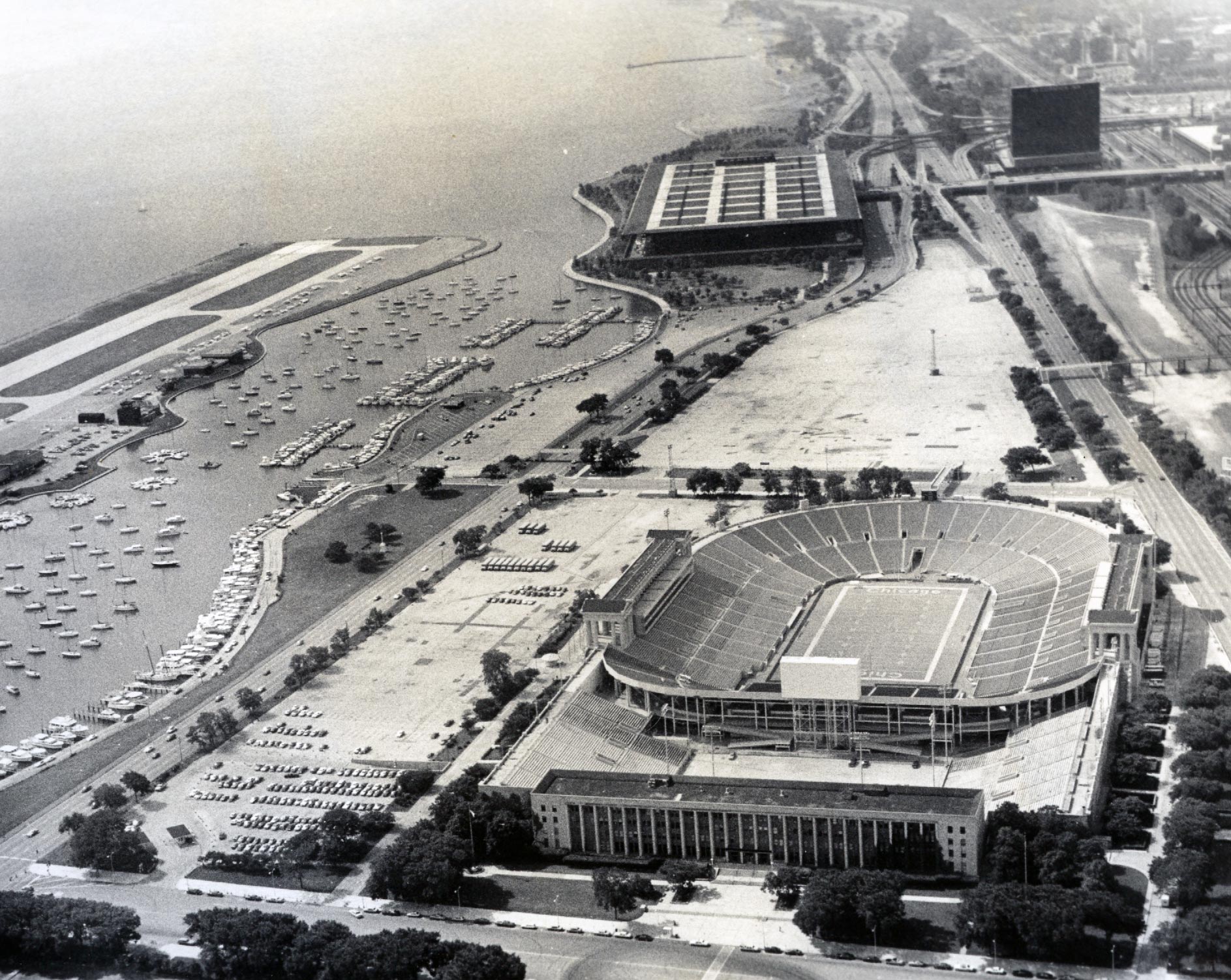 Aerial view of Chicago Park District Administration Building and Soldier Field looking south, ca. 1975. Chicago Park District Records: Photographs, Special Collections, Chicago Public Library.