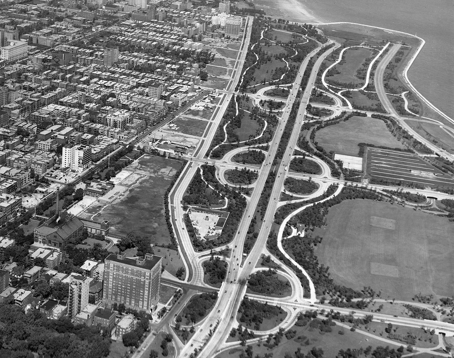 This aerial view shows the newly extended Marine Drive from Montrose to Foster avenues. The Marine Drive Apartments can be seen at the very top of this photo (just left of the 1923 Aquitania Building), ca. 1940. Chicago Park District Records: Photographs, Special Collections, Chicago Public Library.