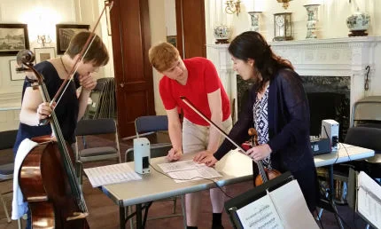 Michael works on “a sky a silver” with cellist Alexis Gerlach and violinist Harumi Rhodes.