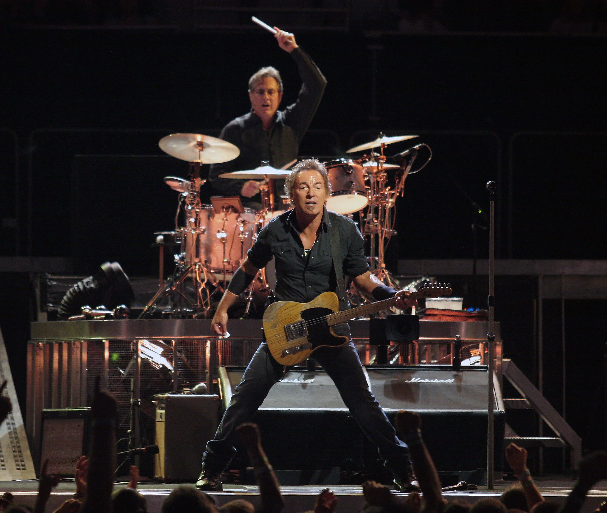 Bruce Springsteen (with Max Weinberg in background on drums) in concert
