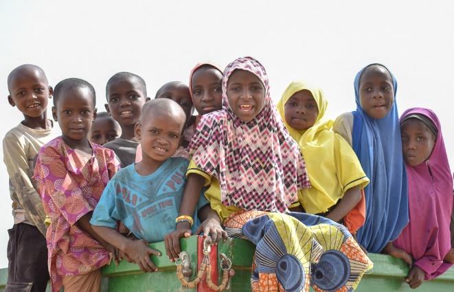 They were sitting on top of a wagon watching a soccer match at Wuro Nyako!