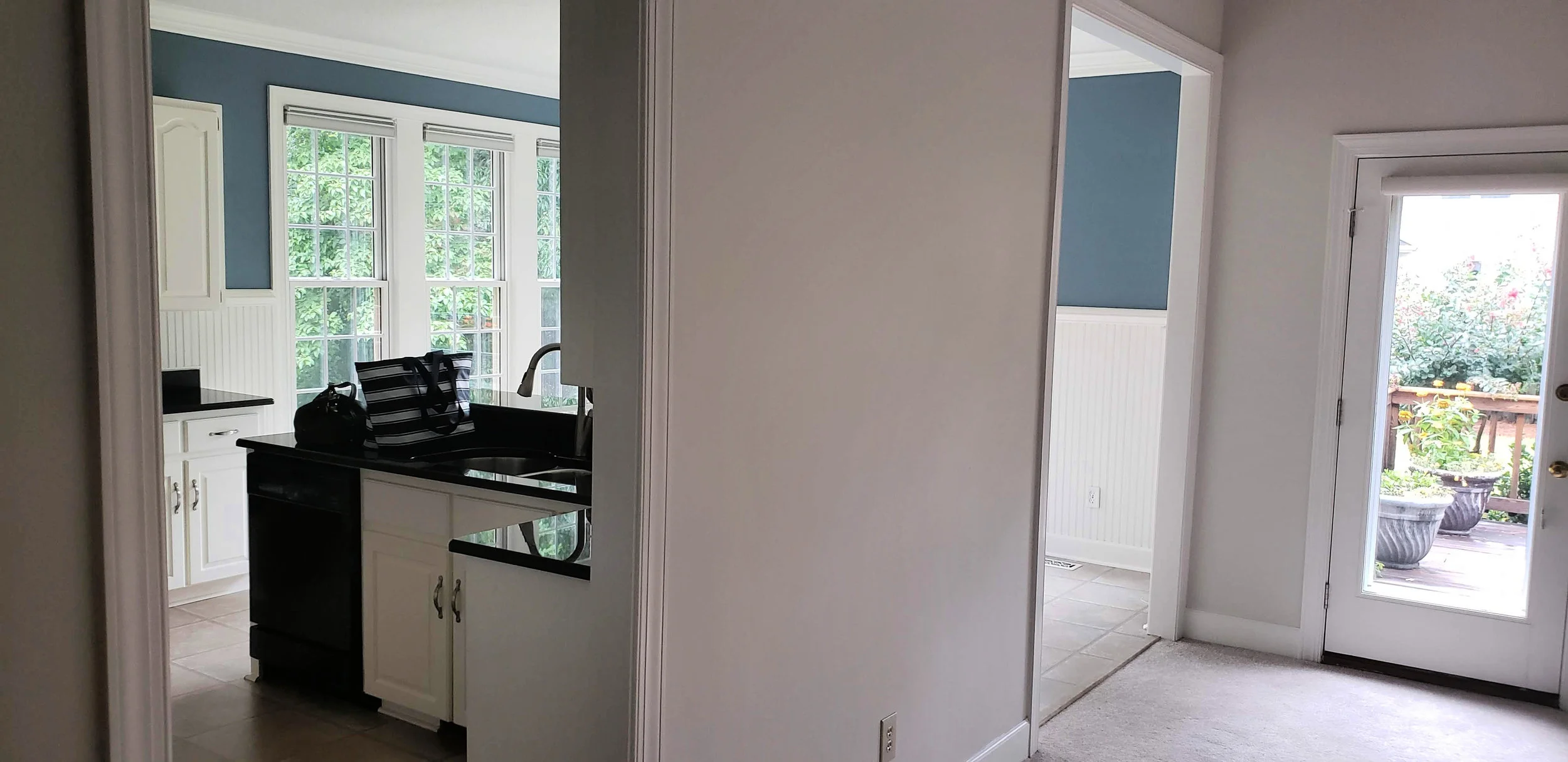 Original hardwood floors in the front of the house ran into carpet and faux tile throughout the rest of the home. That would all go…along with the wall above separating part of the kitchen from the great room.
