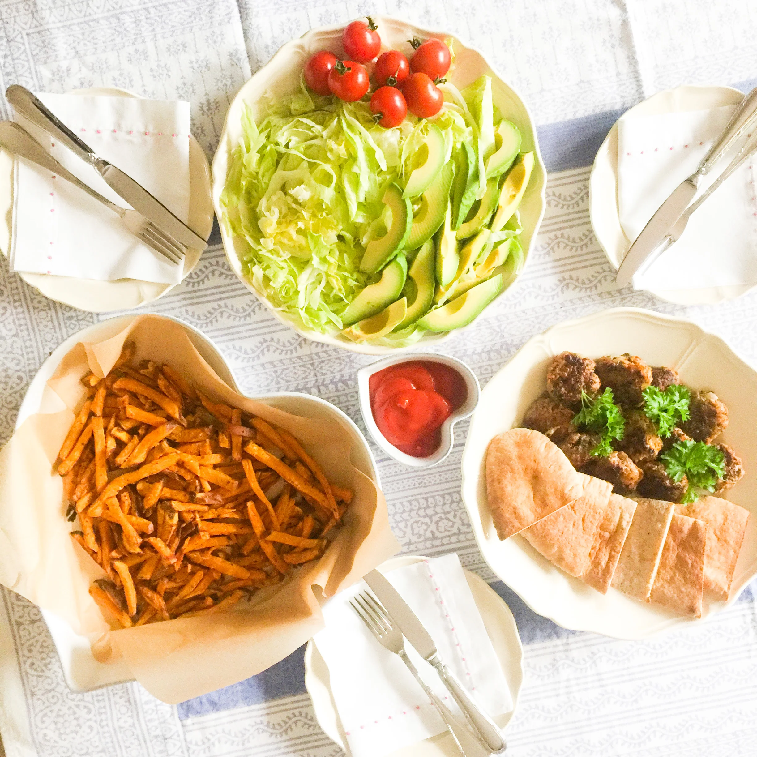 Mini Burgers, pitta pockets, homemade sweet potato chips, shredded lettuce, sliced avocado and cherry tomatoes (halve or quarter, for small children)