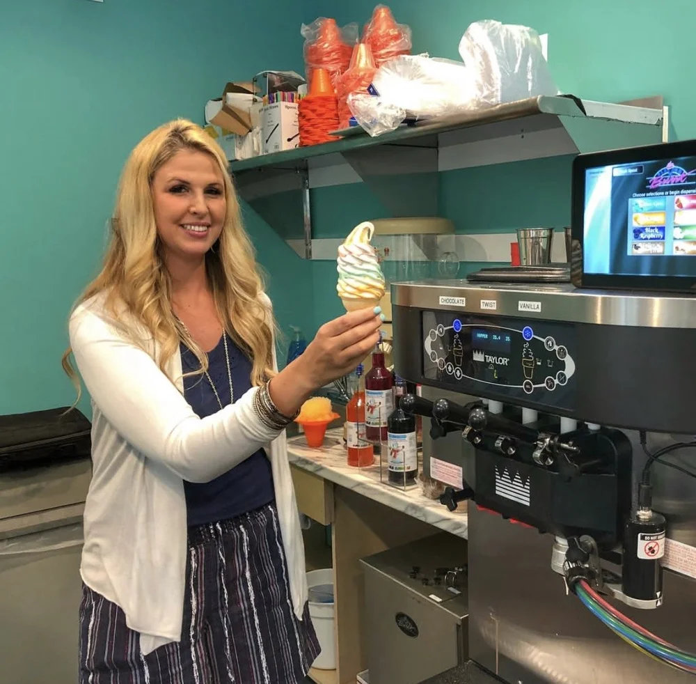 Happy customer holding their first soft serve cone made on their new machine
