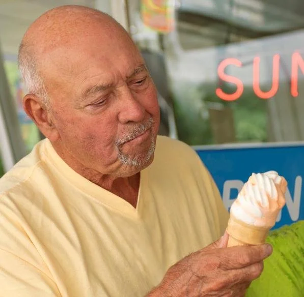 Man enjoying soft serve ice cream cone
