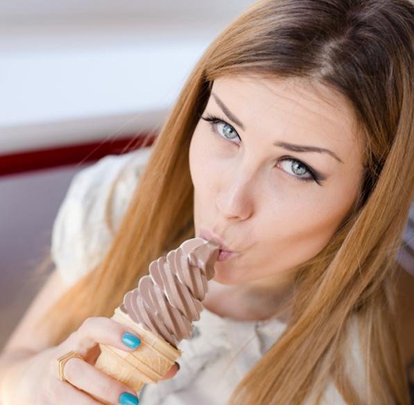 Woman enjoying a chocolate soft serve cone