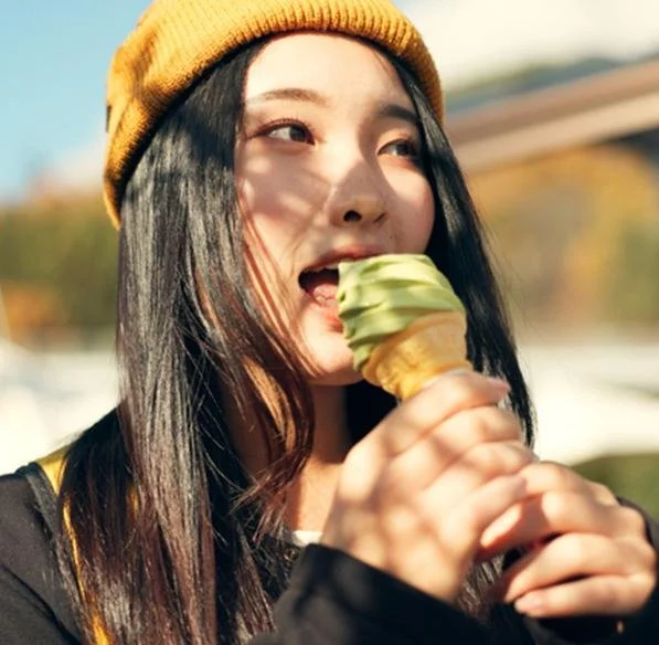Girl enjoying matcha soft serve cone